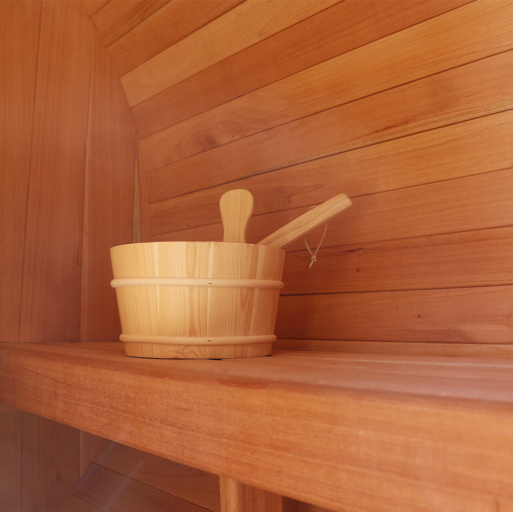 Sauna bucket inside a cedar barrel sauna
